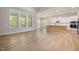 Open concept living and kitchen area with wood floors, large windows, and lots of light at 50 Gadwall Ct, Zebulon, NC 27597