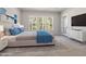 Serene main bedroom with large windows, a plush bed, and minimalist decor for a calming atmosphere at 50 Gadwall Ct, Zebulon, NC 27597