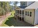 View of the home's screened in porch with wooden steps down into the backyard at 50 Gadwall Ct, Zebulon, NC 27597