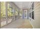 Covered screened porch with wood flooring, white railings, and an open view to the backyard at 50 Gadwall Ct, Zebulon, NC 27597