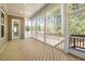 Relaxing screened porch with wood flooring and white railings, perfect for enjoying the outdoors at 50 Gadwall Ct, Zebulon, NC 27597