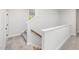 Carpeted staircase with wooden handrail and white risers at 50 Gadwall Ct, Zebulon, NC 27597