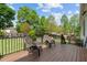 Back deck with patio furniture, a metal railing, and a landscaped back yard at 503 Fish Pond Ct, Rolesville, NC 27571