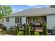 Back exterior view featuring an outdoor deck with comfortable seating and professional landscaping at 503 Fish Pond Ct, Rolesville, NC 27571