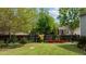 Spacious lawn area enclosed by a wooden fence adorned with decorative windows and lush vegetation at 503 Fish Pond Ct, Rolesville, NC 27571