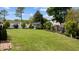 Expansive lawn with a storage shed in the background, surrounded by mature trees and a wooden fence at 503 Fish Pond Ct, Rolesville, NC 27571