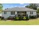 Back exterior view featuring an outdoor deck, professional landscaping, and a well-manicured lawn at 503 Fish Pond Ct, Rolesville, NC 27571