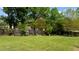Spacious lawn area enclosed by a wooden fence adorned with decorative windows and lush vegetation at 503 Fish Pond Ct, Rolesville, NC 27571
