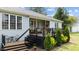 Back exterior featuring an outdoor deck, small table with chairs, and well-manicured landscaping at 503 Fish Pond Ct, Rolesville, NC 27571