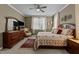 Comfortable bedroom featuring a wooden dresser with a TV, and a cozy floral bed at 503 Fish Pond Ct, Rolesville, NC 27571