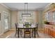 Inviting dining area with a wooden table set, modern lighting, and sunny windows at 503 Fish Pond Ct, Rolesville, NC 27571
