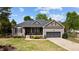 Charming single-story home with a stone-accented front porch, well-manicured lawn, and attached two-car garage at 503 Fish Pond Ct, Rolesville, NC 27571