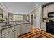 Kitchen breakfast bar with granite counters and stainless sink at 503 Fish Pond Ct, Rolesville, NC 27571