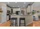 Eat-in kitchen featuring white cabinets, breakfast bar, and modern black appliances at 503 Fish Pond Ct, Rolesville, NC 27571