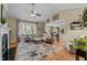 Bright living room with a fireplace, large windows, and an open view into the dining area at 503 Fish Pond Ct, Rolesville, NC 27571