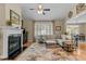 Comfortable living room featuring a fireplace, large windows for natural light, and a seamless flow to the dining area at 503 Fish Pond Ct, Rolesville, NC 27571