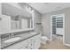 Bathroom with double vanity, granite countertop, large mirror, and walk-in closet at 518 Retreat Ln, Wake Forest, NC 27587