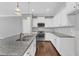 Modern kitchen with stainless steel appliances, granite countertops, and white cabinetry at 518 Retreat Ln, Wake Forest, NC 27587