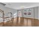 Spacious living room with hardwood floors, stairs, and natural light from large windows at 518 Retreat Ln, Wake Forest, NC 27587
