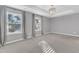 Large main bedroom with carpet, tray ceiling, and multiple windows for natural light at 518 Retreat Ln, Wake Forest, NC 27587