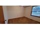 Bedroom showing neutral-colored walls with carpeted floor and wood trim around the window at 530 Broad Rd, Roxboro, NC 27573