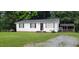 Quaint home with a well-maintained lawn and a detached covered structure in the backyard at 530 Broad Rd, Roxboro, NC 27573