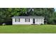 Charming one-story home featuring classic black shutters and a lush green front lawn at 530 Broad Rd, Roxboro, NC 27573