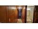 Hallway leading to bathroom; features wood paneling and neutral flooring at 530 Broad Rd, Roxboro, NC 27573
