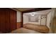View from paneled hall into living room with window, showing layout and flow at 530 Broad Rd, Roxboro, NC 27573