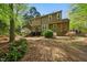 Private backyard with mature trees, a small deck, and plenty of space for outdoor activities at 5610 Frenchmans Creek Dr, Durham, NC 27713