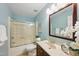 Well lit bathroom with bathtub, sliding glass door and updated vanity at 5610 Frenchmans Creek Dr, Durham, NC 27713