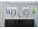 Bathroom with double vanity, framed mirrors, modern fixtures and stylish vanity at 5610 Frenchmans Creek Dr, Durham, NC 27713