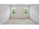 Bedroom with neutral carpet, two windows for ample natural light, and a closet at 5610 Frenchmans Creek Dr, Durham, NC 27713