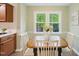 Cozy dining area featuring a wooden table, vintage chairs, and a bright window view at 5610 Frenchmans Creek Dr, Durham, NC 27713