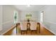 A dining room featuring hardwood floors, neutral paint color, chair rail, and picture frame molding at 5610 Frenchmans Creek Dr, Durham, NC 27713