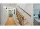 The hallway features hardwood floors, a staircase, and stylish decor at 5610 Frenchmans Creek Dr, Durham, NC 27713