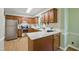 The kitchen features wooden cabinets, stainless steel appliances, and white stone countertops at 5610 Frenchmans Creek Dr, Durham, NC 27713