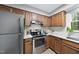 The kitchen has stainless steel appliances, wooden cabinets, and stone countertops at 5610 Frenchmans Creek Dr, Durham, NC 27713