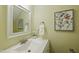 A stylish powder room with a decorative mirror and vanity at 5610 Frenchmans Creek Dr, Durham, NC 27713