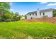 Expansive backyard featuring lush green grass, mature trees, and natural privacy at 5712 Wintergreen Dr, Raleigh, NC 27609