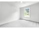 Bright bedroom featuring plush carpeting, a large window, and neutral paint at 5712 Wintergreen Dr, Raleigh, NC 27609