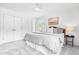 Bright bedroom featuring neutral tones, a ceiling fan, and a wood-framed bed with stylish throw pillows at 5712 Wintergreen Dr, Raleigh, NC 27609