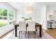 Dining room features a large window, contemporary light fixture, and a stylish dining set at 5712 Wintergreen Dr, Raleigh, NC 27609