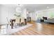 Bright dining area with modern lighting, white paneled wall, open to kitchen and living space at 5712 Wintergreen Dr, Raleigh, NC 27609