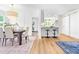 Open concept dining room and kitchen featuring hardwood floors, table with seating for six, and barn door at 5712 Wintergreen Dr, Raleigh, NC 27609