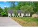 A cozy home with a well-maintained lawn and mature trees, complemented by a neat driveway at 5712 Wintergreen Dr, Raleigh, NC 27609