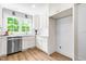 Bright kitchen featuring white cabinets, stainless steel appliances, subway tile backsplash, and quartz countertops at 5712 Wintergreen Dr, Raleigh, NC 27609