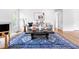 Bright living room with fireplace, stylish decor, hardwood floors and windows to exterior at 5712 Wintergreen Dr, Raleigh, NC 27609
