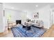 Bright living room with fireplace, stylish decor, hardwood floors and windows to exterior at 5712 Wintergreen Dr, Raleigh, NC 27609