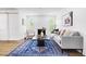 Bright living room with fireplace, stylish decor, hardwood floors and windows to exterior at 5712 Wintergreen Dr, Raleigh, NC 27609